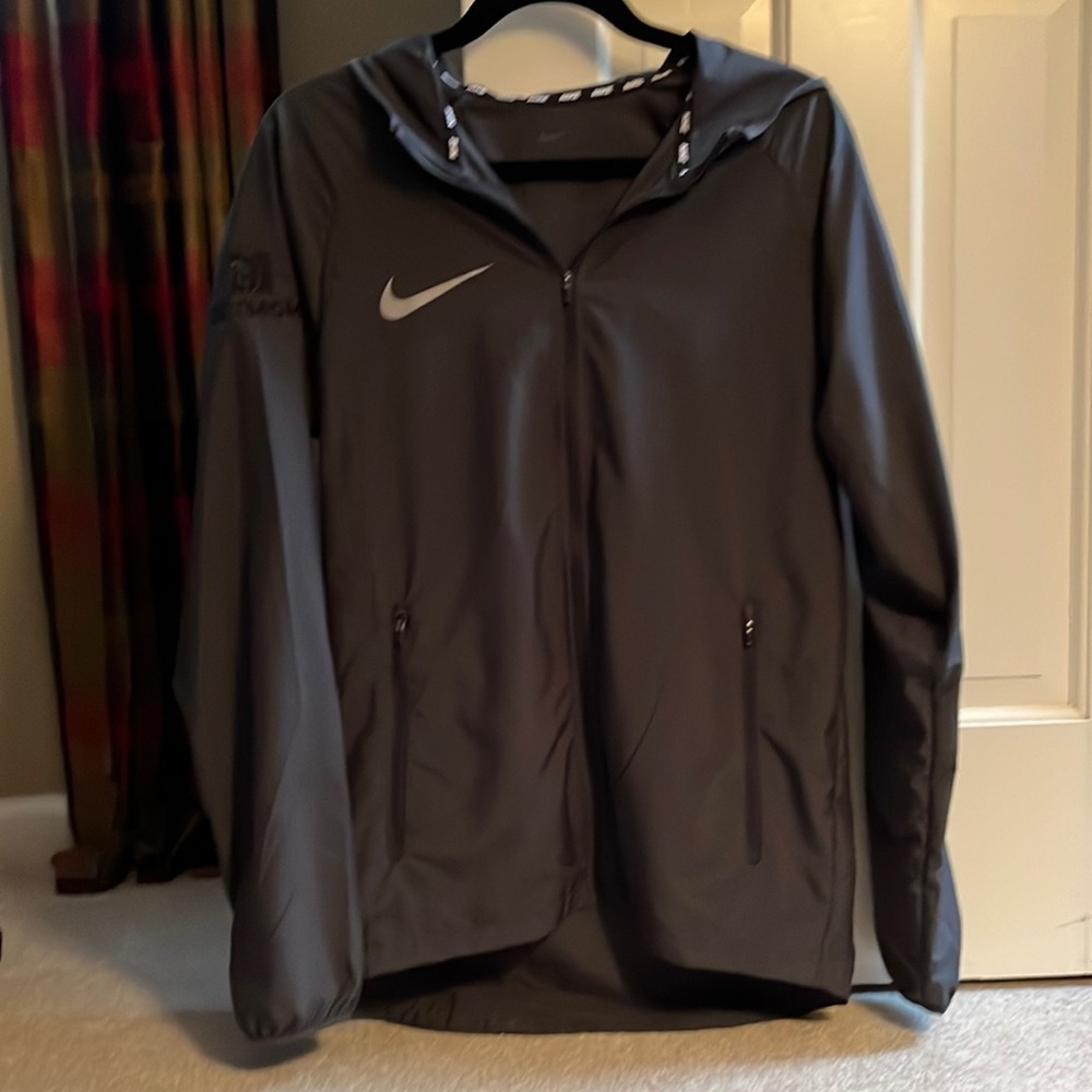 Nike jacket 100% polyester w/ hood. sleeve has imprint Bet MGM & Bellagio